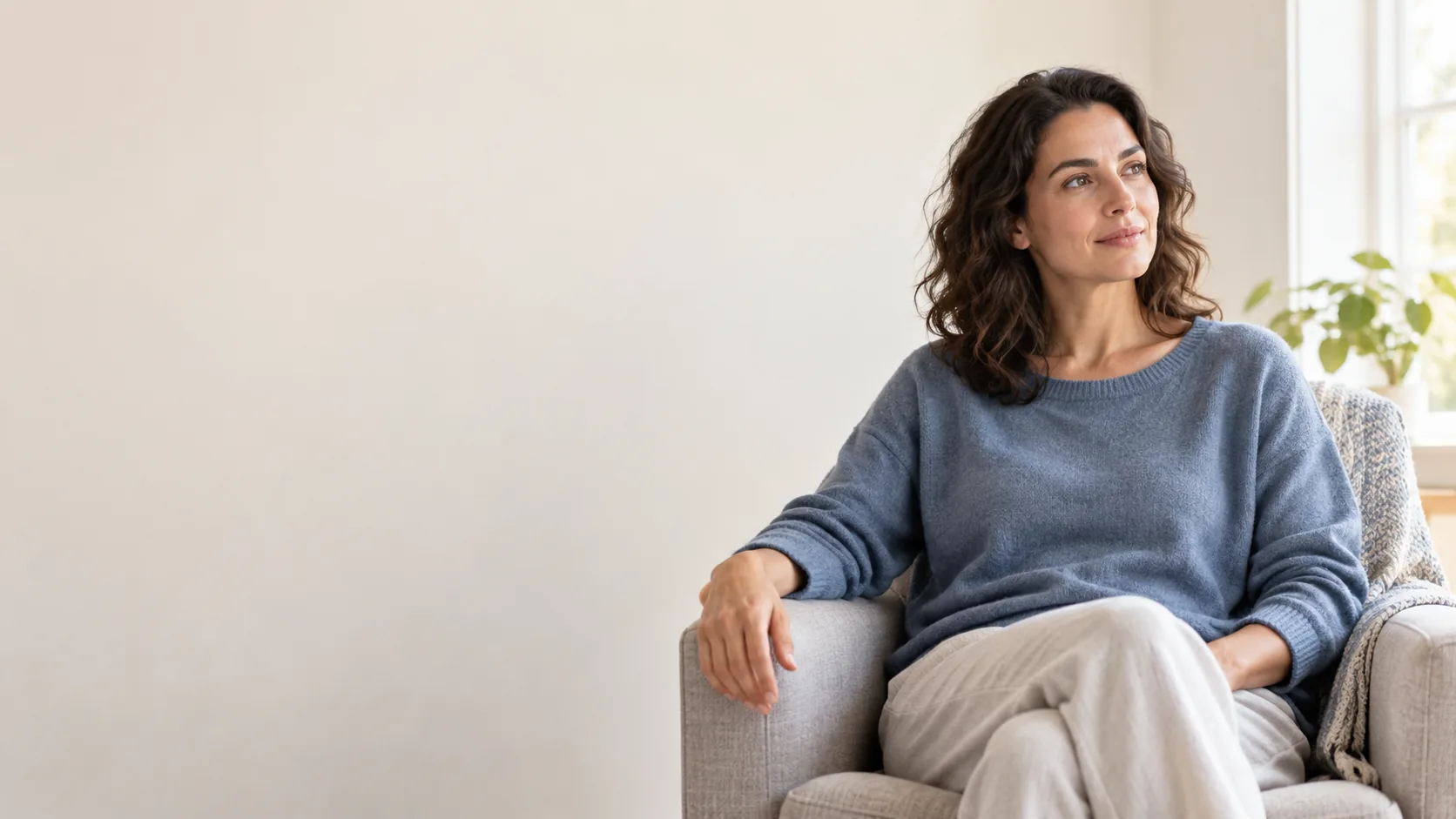 Fictional adult seated quietly in a light indoor room.